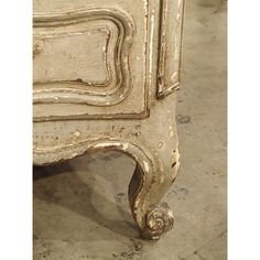 an old white dresser with ornate carvings on it's sides and drawers is shown