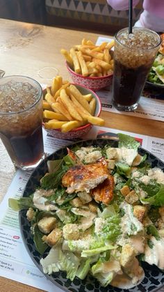 a salad and french fries on a table