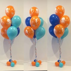 three balloons are arranged in the shape of an octopus and one is blue, orange and white