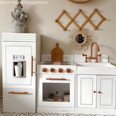 a white toy kitchen with orange accents