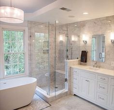 a large bathroom with a tub, sink and shower stall in it's corner