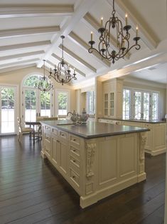 a large kitchen with an island and chandelier