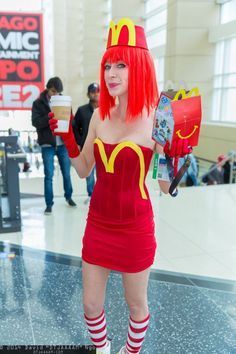 a woman dressed as a mcdonald's girl holding a cup of coffee