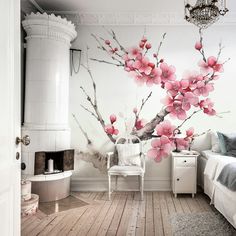 a bedroom decorated in white with pink flowers on the wall