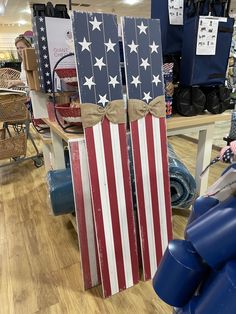 two wooden american flags are on display in a store, one is red white and blue