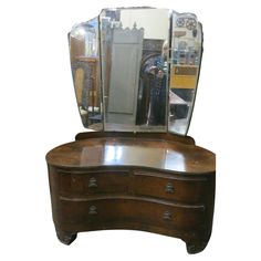 a wooden dresser with a mirror on top of it