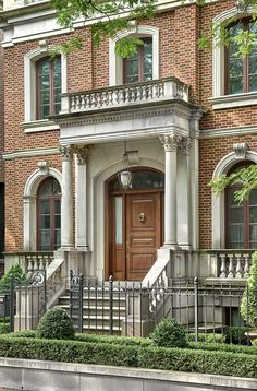 a large brick building with stairs leading up to the front door