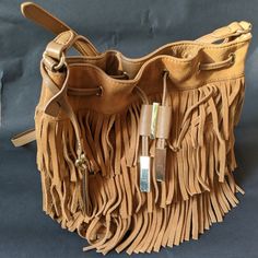 New - Never Used - Beautiful Vince Camuto Joni Tobbaco Brown Suede Leather Shoulder Bag. Leather; Single Shoulder Strap Drawstring And Magnetic Snap Closures Exterior Features Shiny Gold-Tone Hardware And Fringe Detail 12-1/4" W X 11-1/4" H X 4-1/4" D. Never Used Vince Camuto Bag, Brown Suede, Vince Camuto, 4 H, Suede Leather, Leather Shoulder Bag, Bucket Bag, Shoulder Strap, Gold Tones