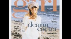 a woman standing on top of a magazine cover next to the ocean with her hands in her pockets