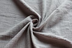 a close up shot of the textured fabric on a white bed sheet or comforter