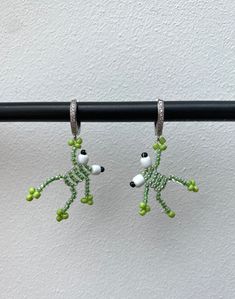 pair of green and white beaded dog earrings