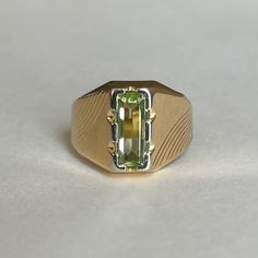 Mid Century Italian 18K Green Spinel Ring, Size 5.5, 3.5grams Size: 5.5 Weight: 3.5 grams Stone: Green Spinel Size Stone: ca. 10mm x 4mm   Number of Gemstones: 1 Cut: Emerald Bandwidth: ca 3.2mm at smallest point Markings:  Condition: Good preowned,  usage throughout -refer to pictures for condition.  All jewelry will be professionally cleaned before shipping and come in a beautiful little gift box. Returns accepted but are subjected to a 8% restock fee. Returns are only accepted for national orders. Green 14k Stamped Signet Ring, Classic Yellow Signet Ring With Polished Finish, Green 14k Gold Signet Ring Fine Jewelry, Luxury Yellow Gold Peridot Rings, Green Signet Ring With Polished Finish For Promise, Classic Green Signet Ring For Anniversary, Green Classic Signet Ring For Anniversary, Heirloom Yellow Gold Signet Ring With Gemstone, Formal Green Sapphire Ring With Vvs Clarity