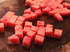 chopped up watermelon cubes on a cutting board