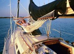 a woman relaxing in a hammock on a sailboat