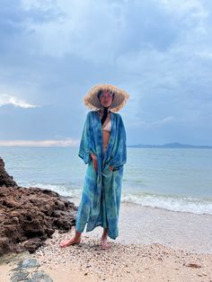 Enhance your everyday style with the subtle allure of patterns and colors in our Dragon Tie Dye Kimono Jacket, inspired by the ocean. This kimono robe effortlessly embodies chic resort-style vibes while ensuring comfort. Hand-stitched from 100% soft rayon fabric and meticulously tie-dyed by skilled artisans, it boasts both quality craftsmanship and artistic flair. With a dropped hemline and a flowing oversized fit, this long kimono jacket effortlessly infuses a laid-back, cool aesthetic into all Vacation Beach Cover-up Kimono With Kimono Sleeves, Blue Open Front Cover-up For Vacation, Blue Bohemian Robe With Kimono Sleeves, Blue Flowy Cover-up With Kimono Sleeves, Blue Beachwear Cover-up For Loungewear, Bohemian Beach Robe For Beach Season, Oversized Blue Kimono For Beach Cover-up, Blue Beachwear Kimono For Poolside, Blue Beachy Cover-up For Loungewear