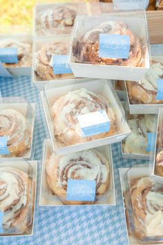 there are many different types of pastries in the trays on the blue and white tablecloth