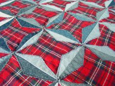 a red and blue quilt with stars on it