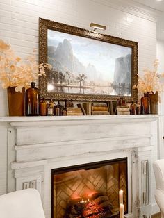 a fireplace with a painting on the mantle