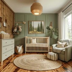 a baby's room with green walls and wooden floors