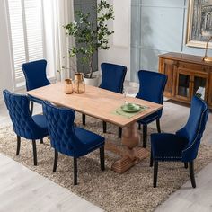 a dining room table with blue chairs around it