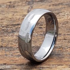 a wedding ring on top of a wooden table