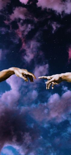 two hands reaching out towards each other in front of purple and blue sky with clouds