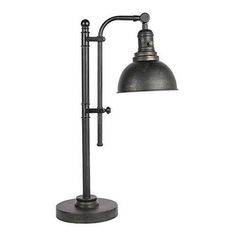 an industrial style desk lamp with a metal shade on the top and bottom, in black