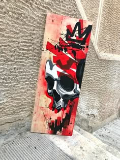 a skateboard with a skull painted on it