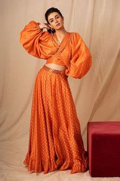 Orange wrap crop top with puff sleeves, mirror work and bandhani pattern.
Component: 1
Pattern: Embroidered
Type Of Work: Bandhani,Mirror
Neckline: V Neck
Sleeve Type: Puff
Fabric: Chanderi
Color: Orange
Other Details: 
Note: Skirt and green outfit worn by the other model is not for sale
Occasion: Sangeet,Mehendi and Haldi - Aza Fashions Mirror Fabric, Bandhani Pattern, Pattern Crop Top, Crop Top For Women, Blouse Casual Fashion, Crop Tops Online, Patterned Crop Top, Pattern Skirt, Lehenga Skirt