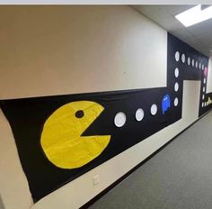 an office hallway decorated in black, yellow and white with polka dots on the wall