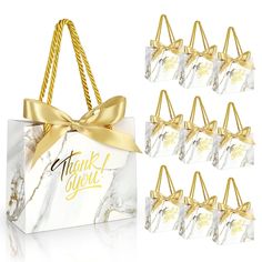 marble gift bags with gold ribbon and thank you tags on them, set of 12