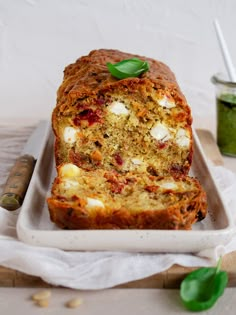 a loaf of meatloaf with cheese and spinach on a white platter