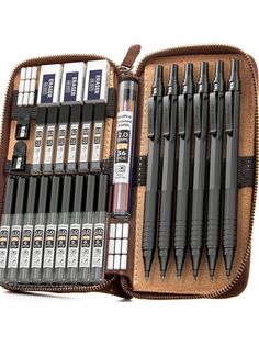 a leather case filled with different types of pens and ink