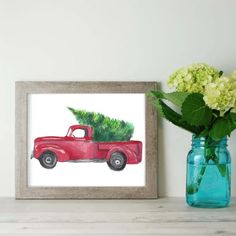 a painting of a red truck with a christmas tree in the bed is displayed next to a vase filled with hydrangeas