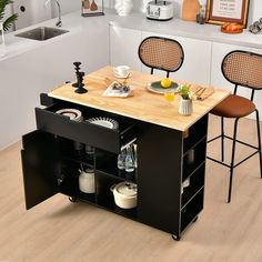 a kitchen island with two stools and a cutting board