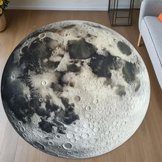 a large round rug with black and white moon phases on it in a living room