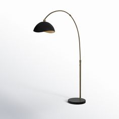 a black and gold floor lamp on a white background with the light turned off to show its dim lighting