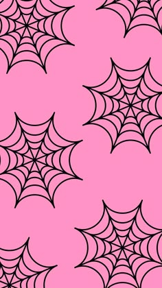 a pink background with black and white spider webs