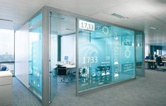 an office cubicle with glass partitions and desks