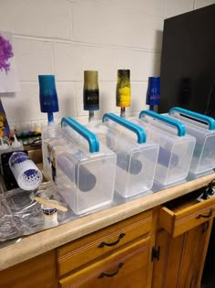 four plastic storage containers sitting on top of a counter