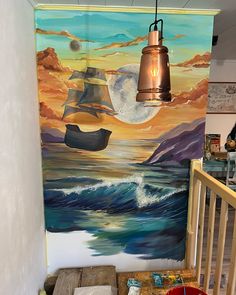 a painting on the wall in a room with stairs and a light fixture hanging over it