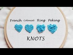 three blue crocheted hearts on a white background with the words knots written below