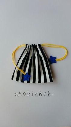 a black and white striped bag with blue stars on the side, which says chokt choki