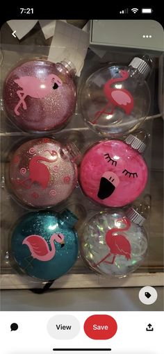 some pink flamingo ornaments are in a box