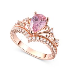 a pink diamond ring with diamonds on the band and an intricate crown design around it