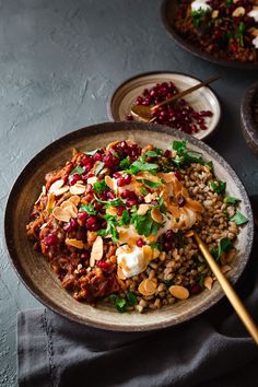 a bowl filled with rice, nuts and greens