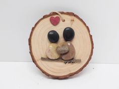 a wooden slice with a couple sitting on top of it and the price is $ 10 on etsy