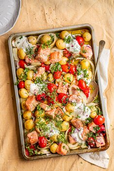 a tray filled with lots of food on top of a wooden table