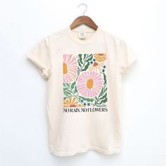 Looking for a cute versatile top to wear? Make sure to grab one of our Graphic tees! This soft and comfortable graphic tee is the perfect top for any outfit. It can be paired with biker shorts, jeans, or even a simple skirt/dress! This tee is true-to-size, so be sure to order your regular t-shirt size! If you are looking for a more oversized look, make sure to size up! Cream Cotton T-shirt With Graphic Print, Hand Printed Graphic Tee For Summer, Summer Beige T-shirt With Screen Print, Beige Screen Print T-shirt For Summer, White Relaxed Fit T-shirt With Watercolor Print, Graphic Print Beige T-shirt, Girly Graphic Tees, Spring Hand Printed Crew Neck Tops, Spring Cream Top With Screen Print