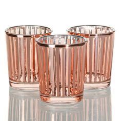 three pink glass cups sitting next to each other